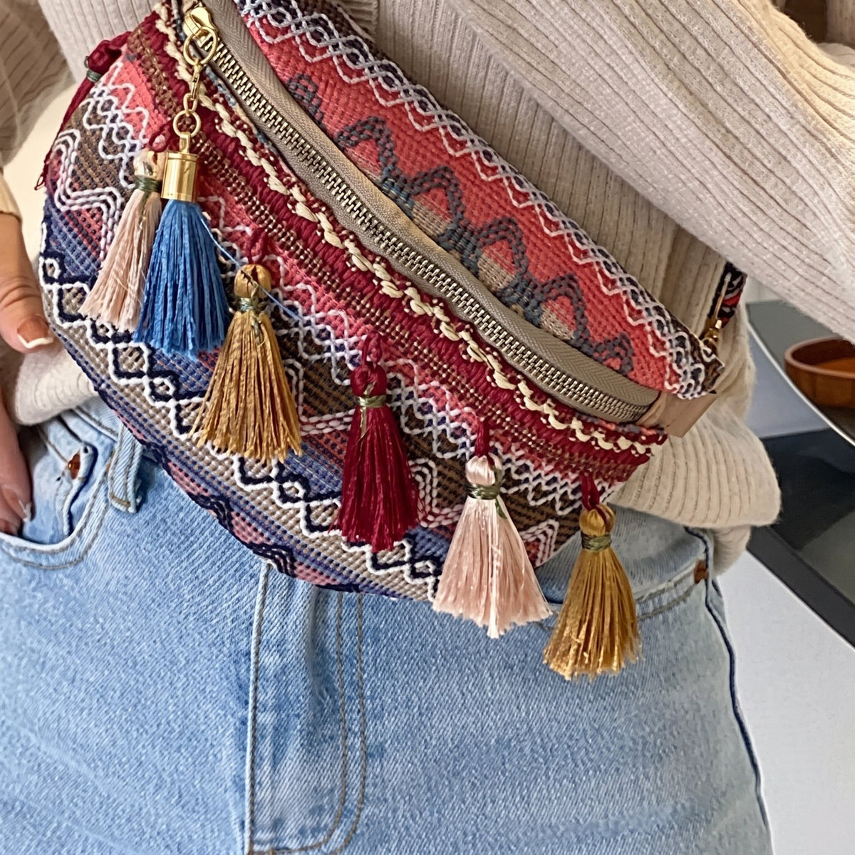 Détail tissage jacquard et pompons du sac banane hippie