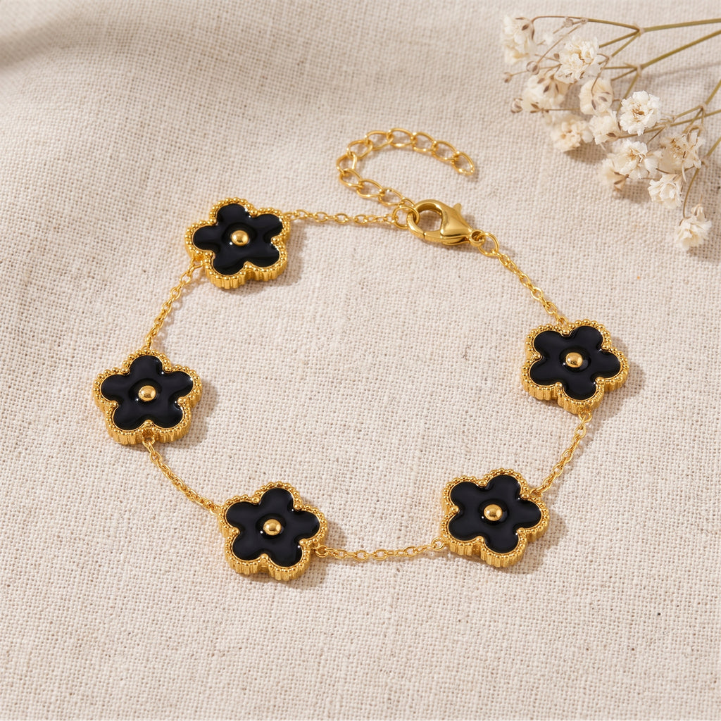 Bracelet fleur 5 pétales noir émaillé, bille dorée centrale, chaîne dorée