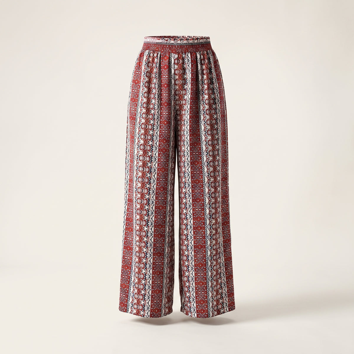 Pantalon hippie large imprimé ethnique rouge et écru présenté sur mannequin invisible, taille haute, fond studio écru